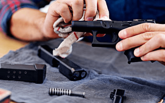 A man  cleaning a gun
